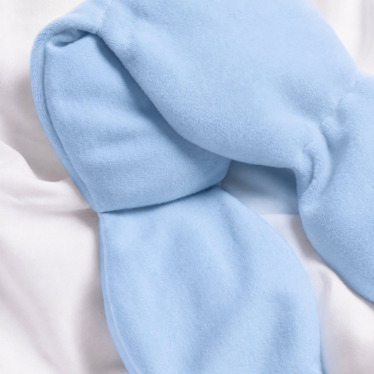Dozzli weighted sleep mask wrapped around a hand, showing it folds flat